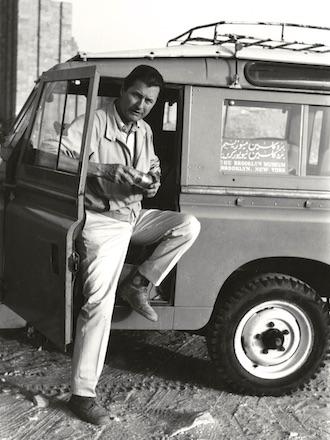 old black and white photograph of Bernard V. Bothmer stepping out of a car in Saqqara, 1969